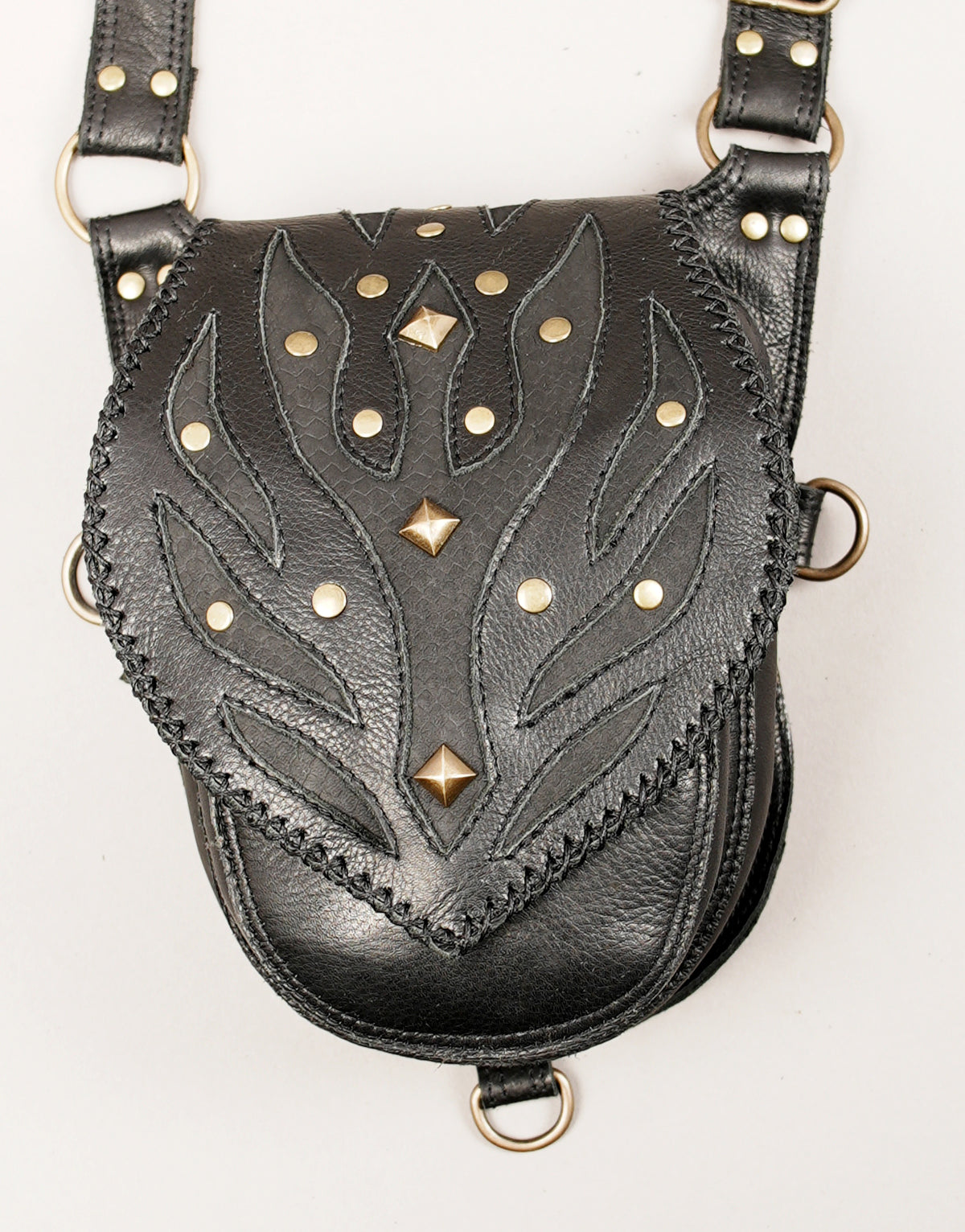 Handmade black leather dual pocket thigh bag with embossed patterns and antique brass-tone studs for Burning Man.