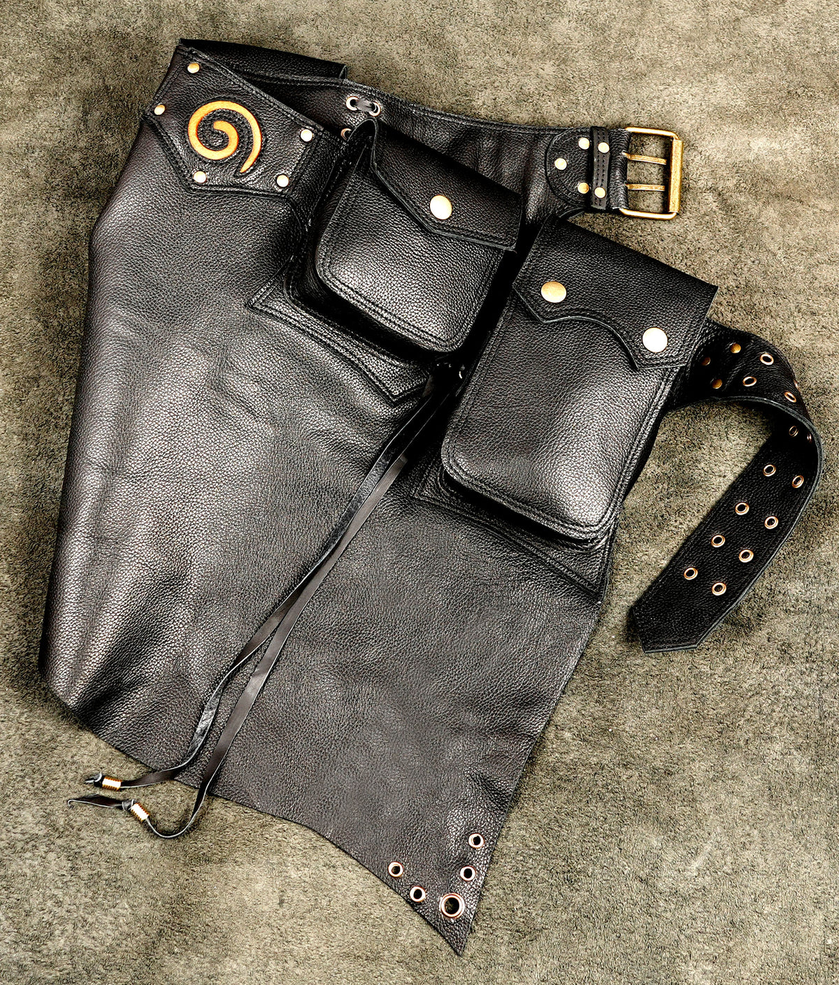 Multi pocket leather skirt with snap closures, close up view
