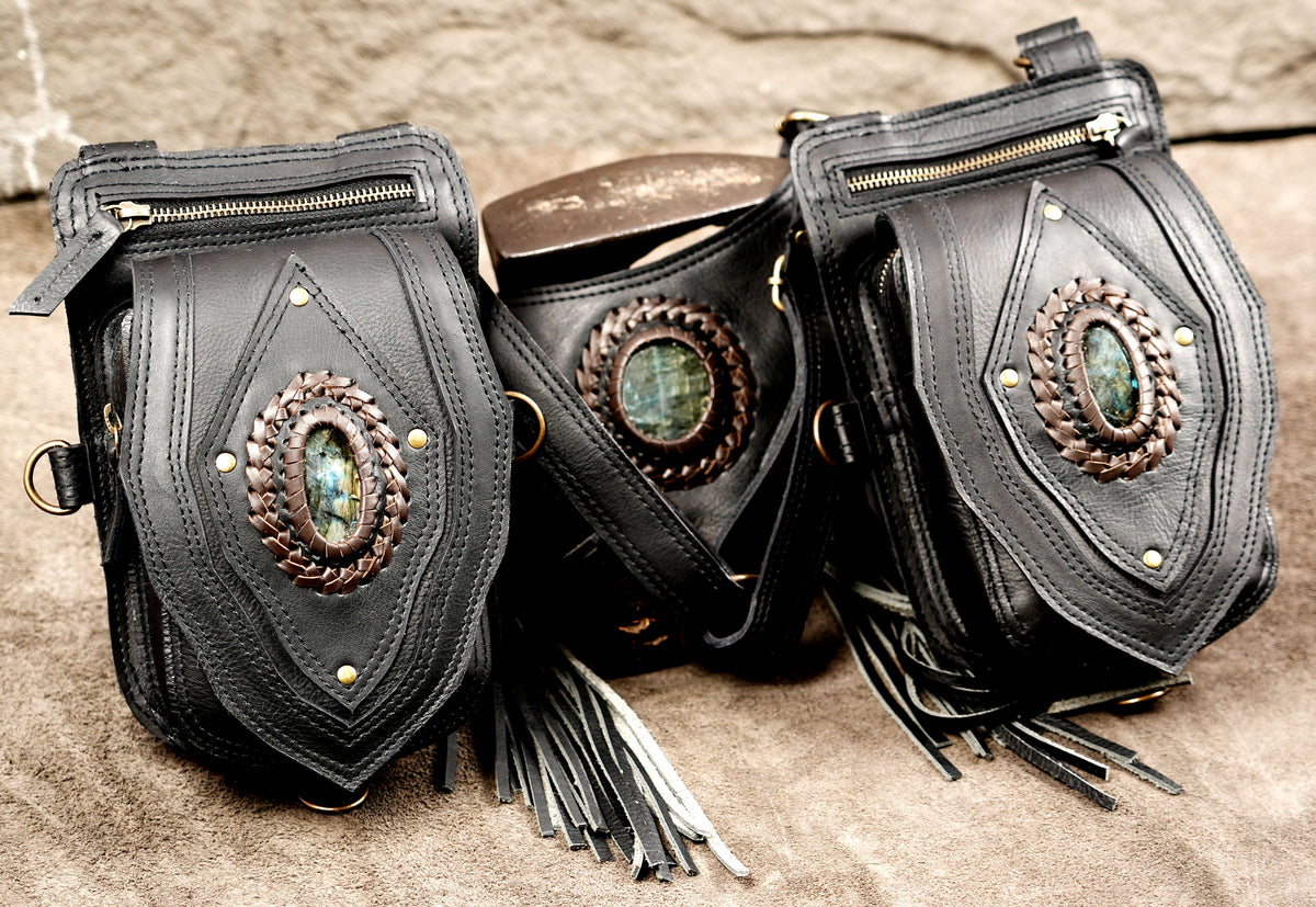 Concealed-style black leather dual shoulder bag with braided stone accents and fringe back piece.