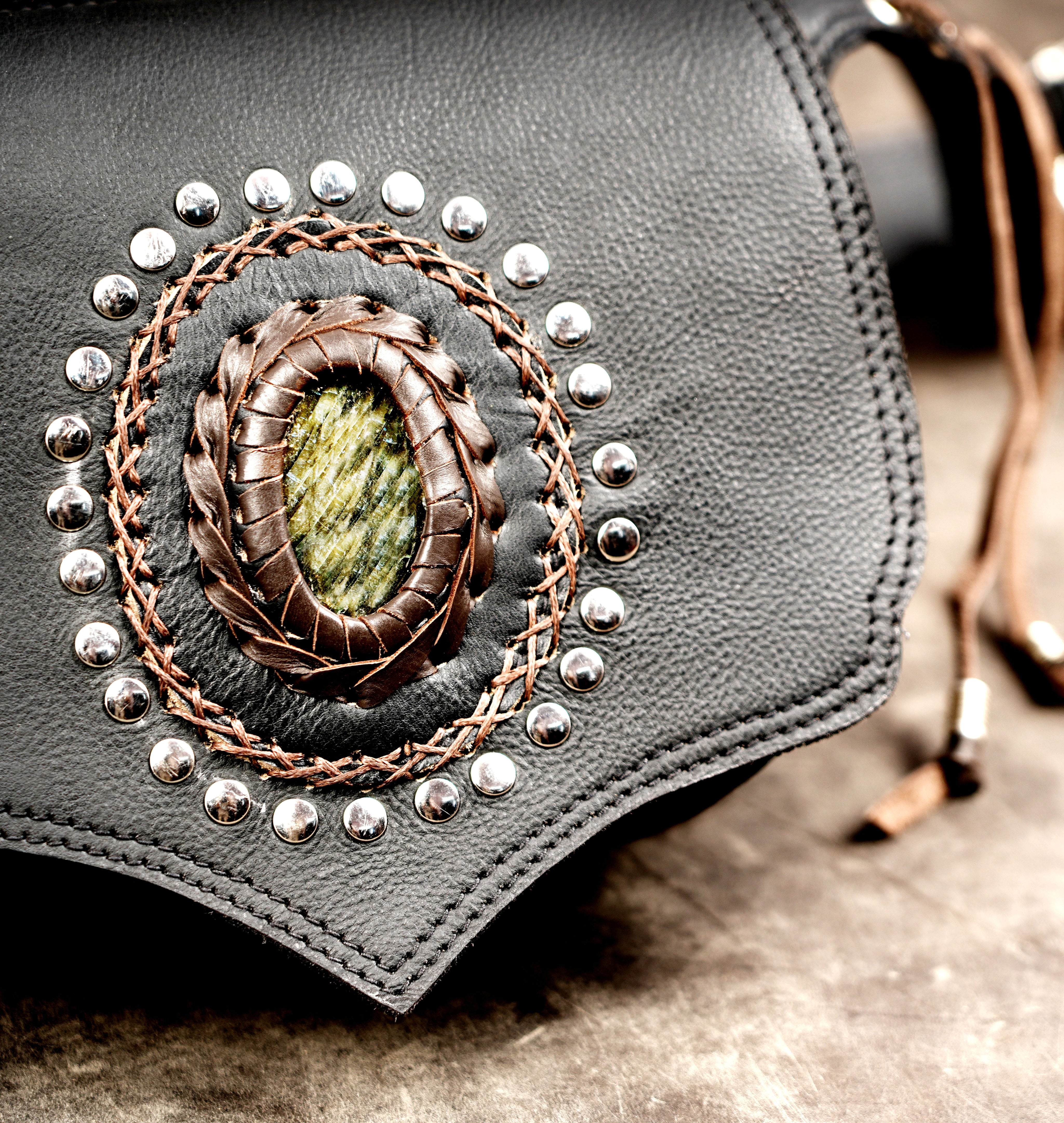 Pointed leather waist bag, stud ring close up view