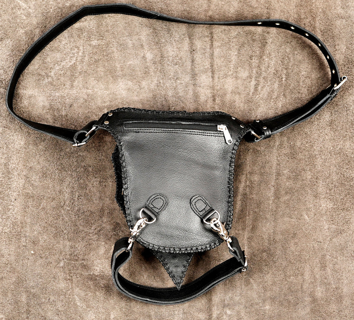 Post-apocalyptic leather thigh bag, stud pattern close up