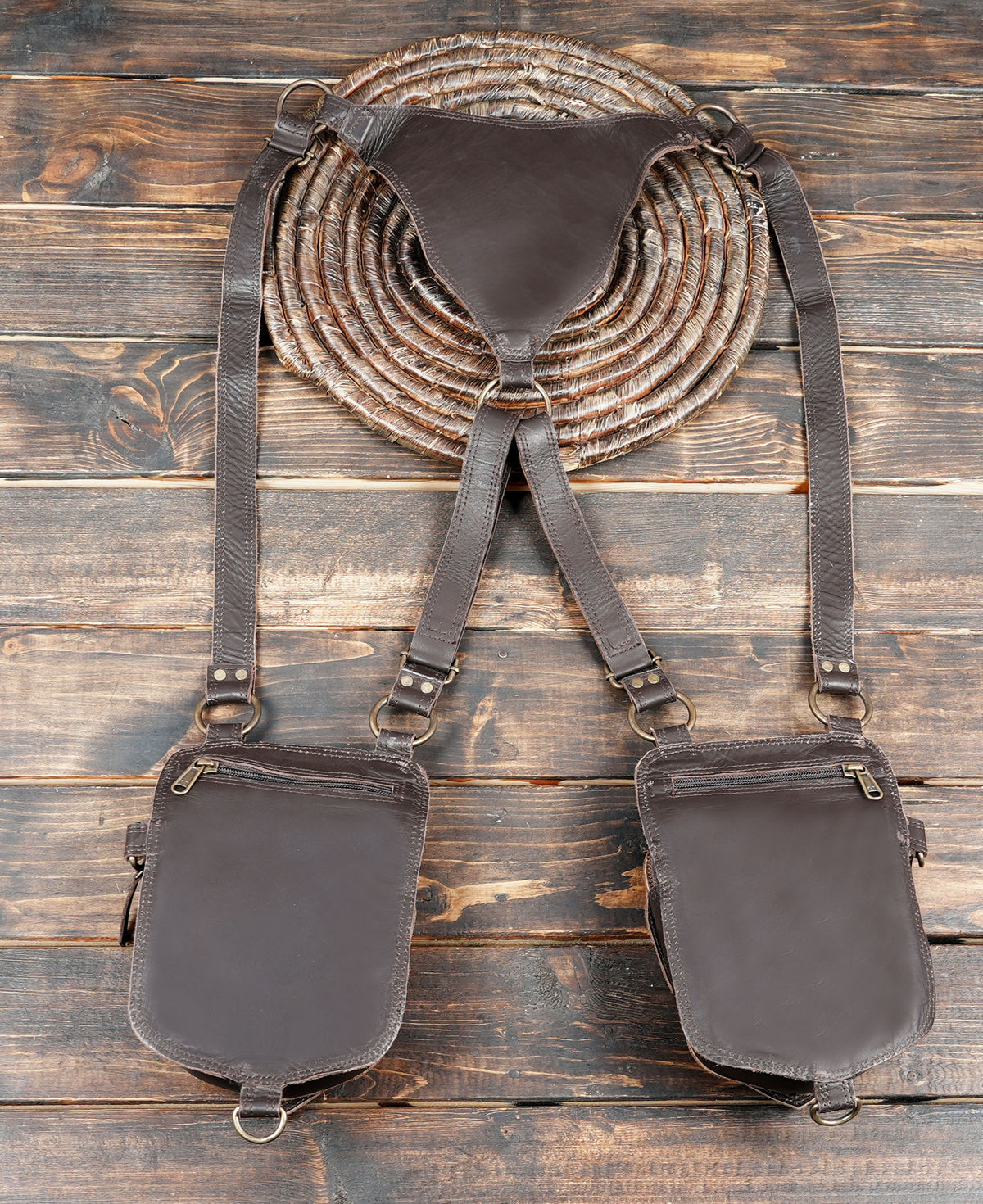 Double pocket leather harness bag with adjustable buckled straps for unisex styling