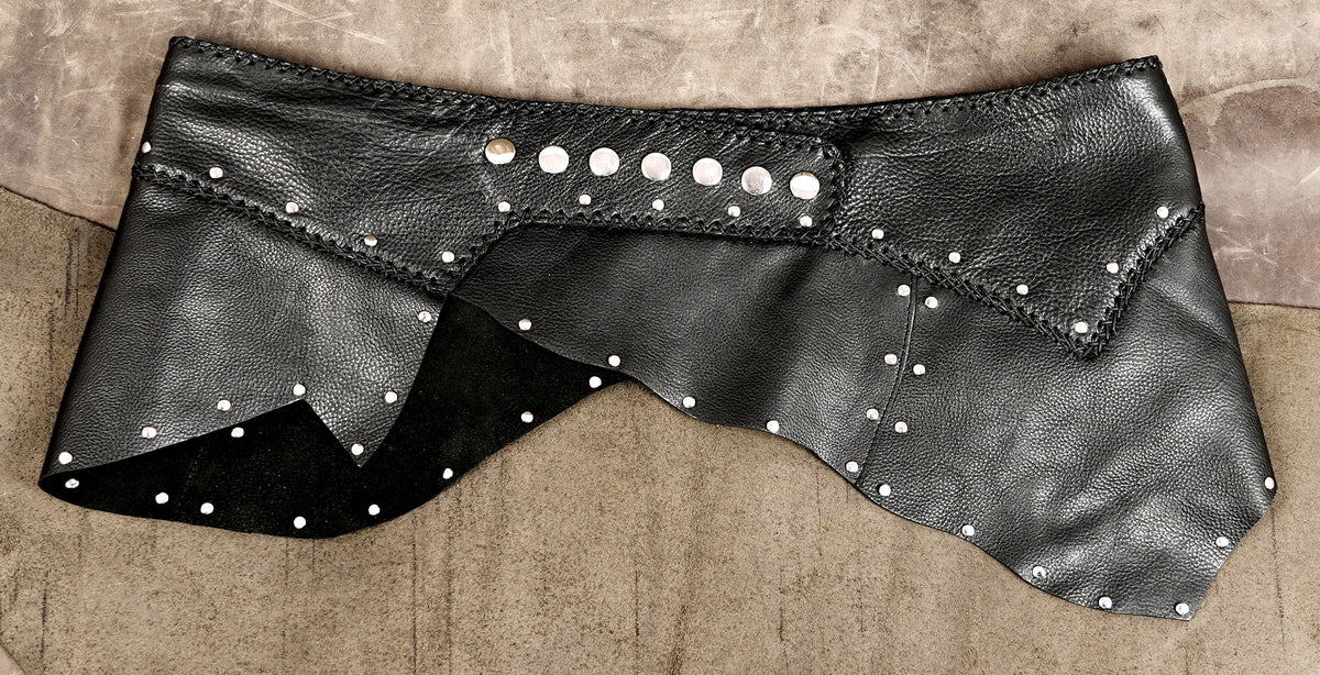 Punk-inspired leather wrap skirt with a curved hem