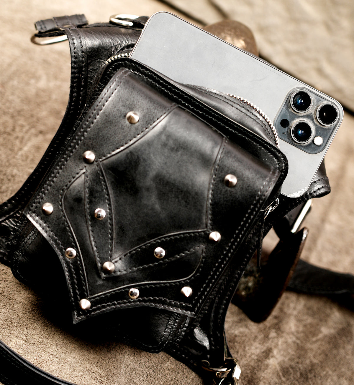 Punk style leather thigh holster, top flat lay view