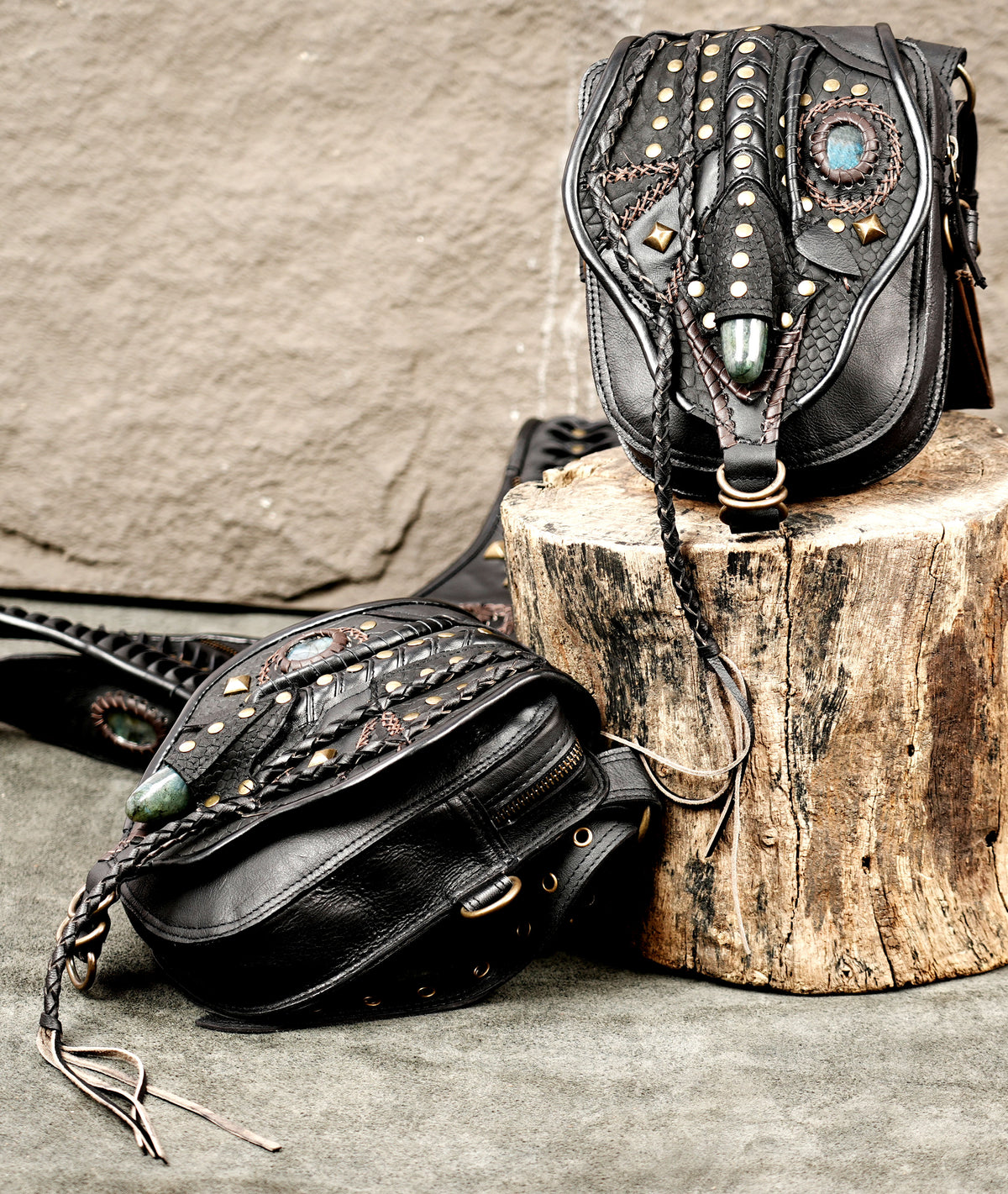 Gothic black leather hip pouch set with studded straps and decorative gemstone details
 