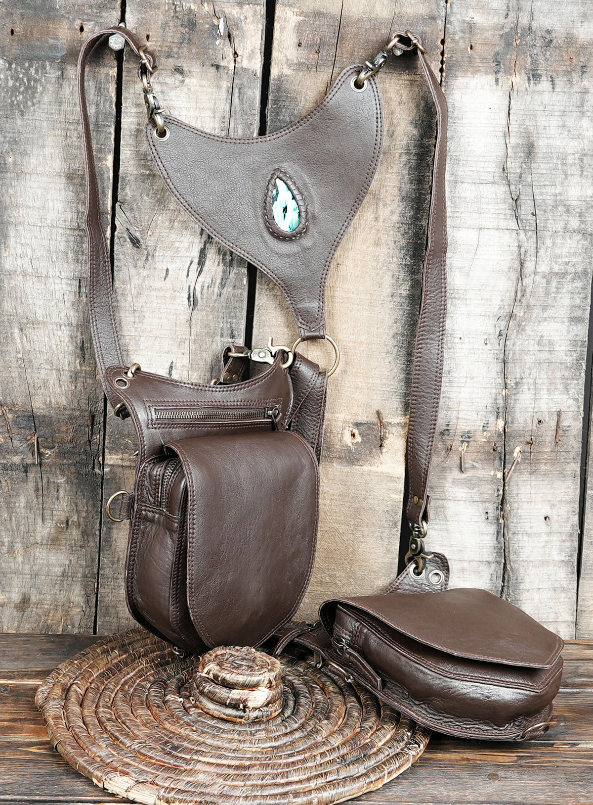 Brown leather festival harness with turquoise stone centerpiece and metal clips
