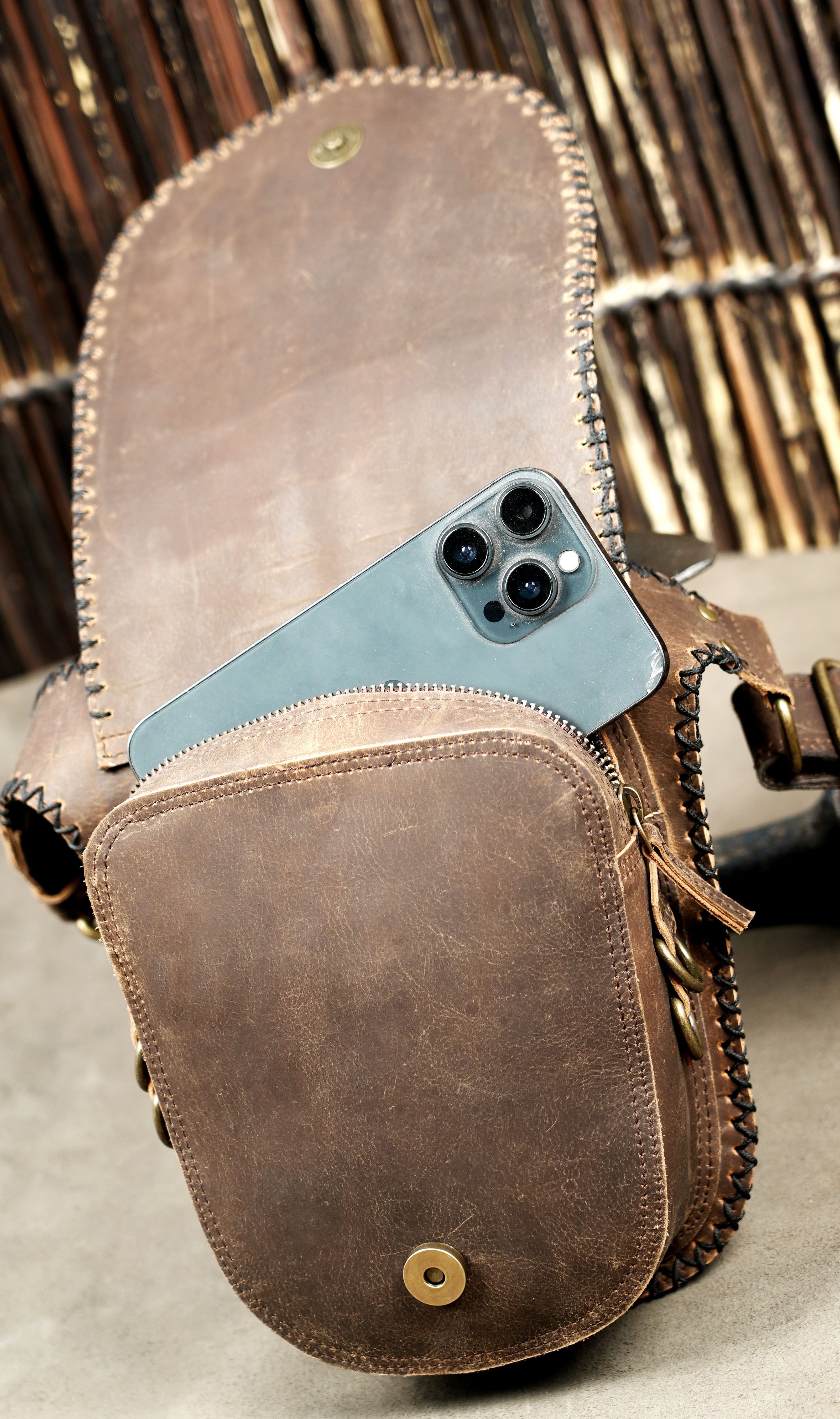 Rugged brown leather utility pouch and hip belt designed for creators and travelers