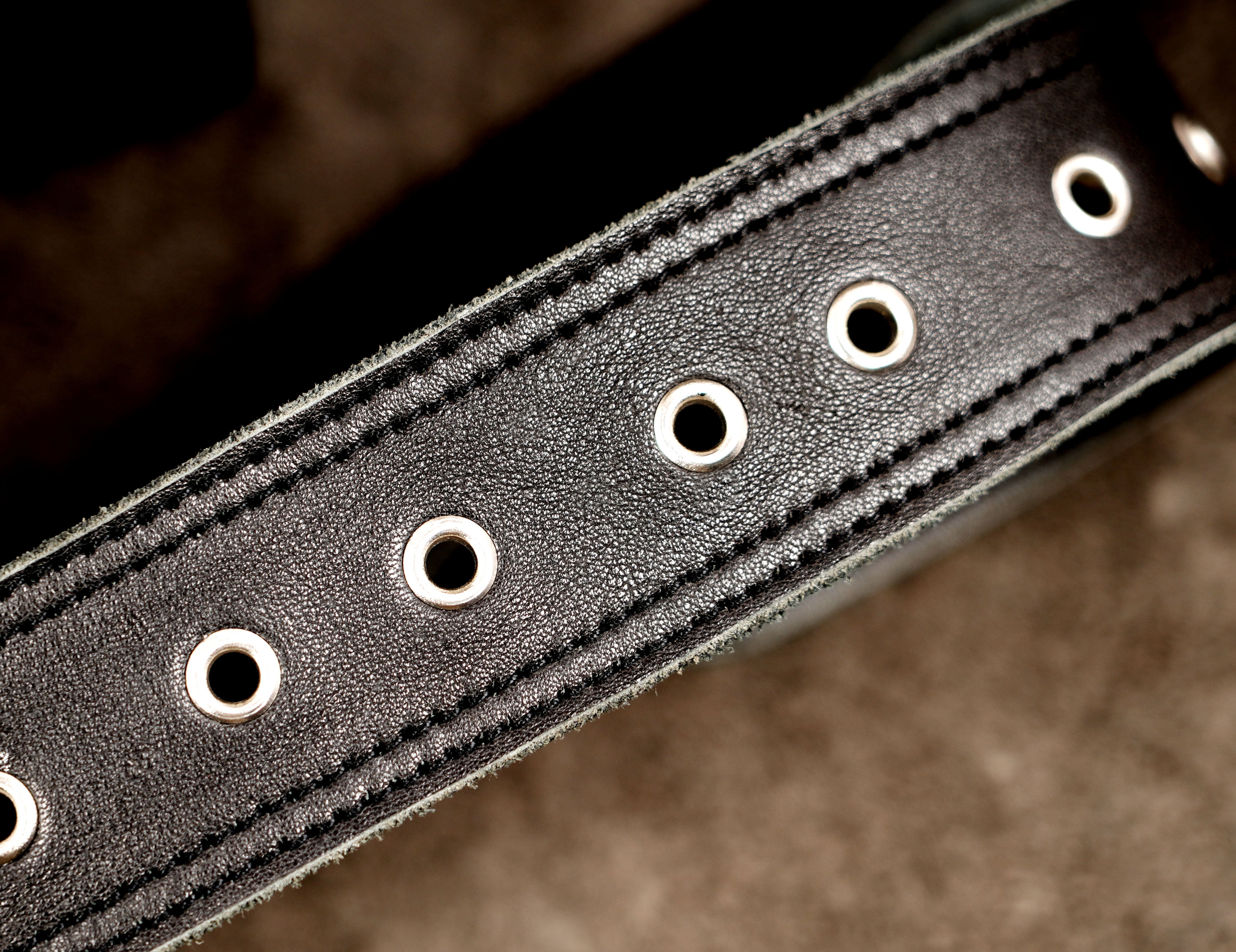 Simple leather hip bag with nickel silver snaps, close up view