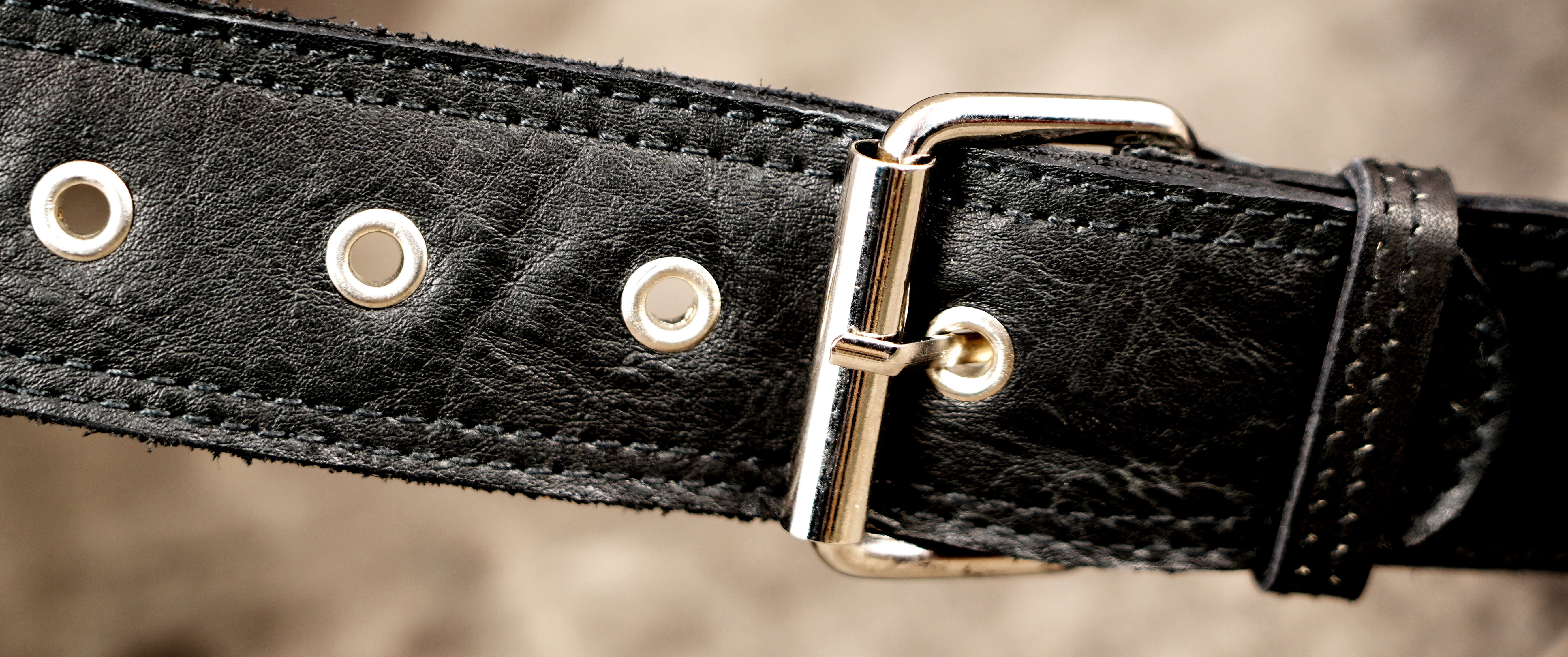 Simple leather hip bag with silver hardware, close up view