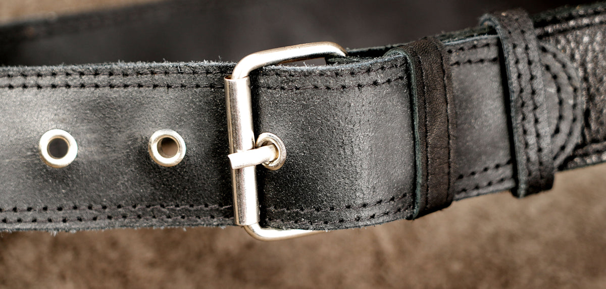 Simple leather hip bag with silver hardware, close up view