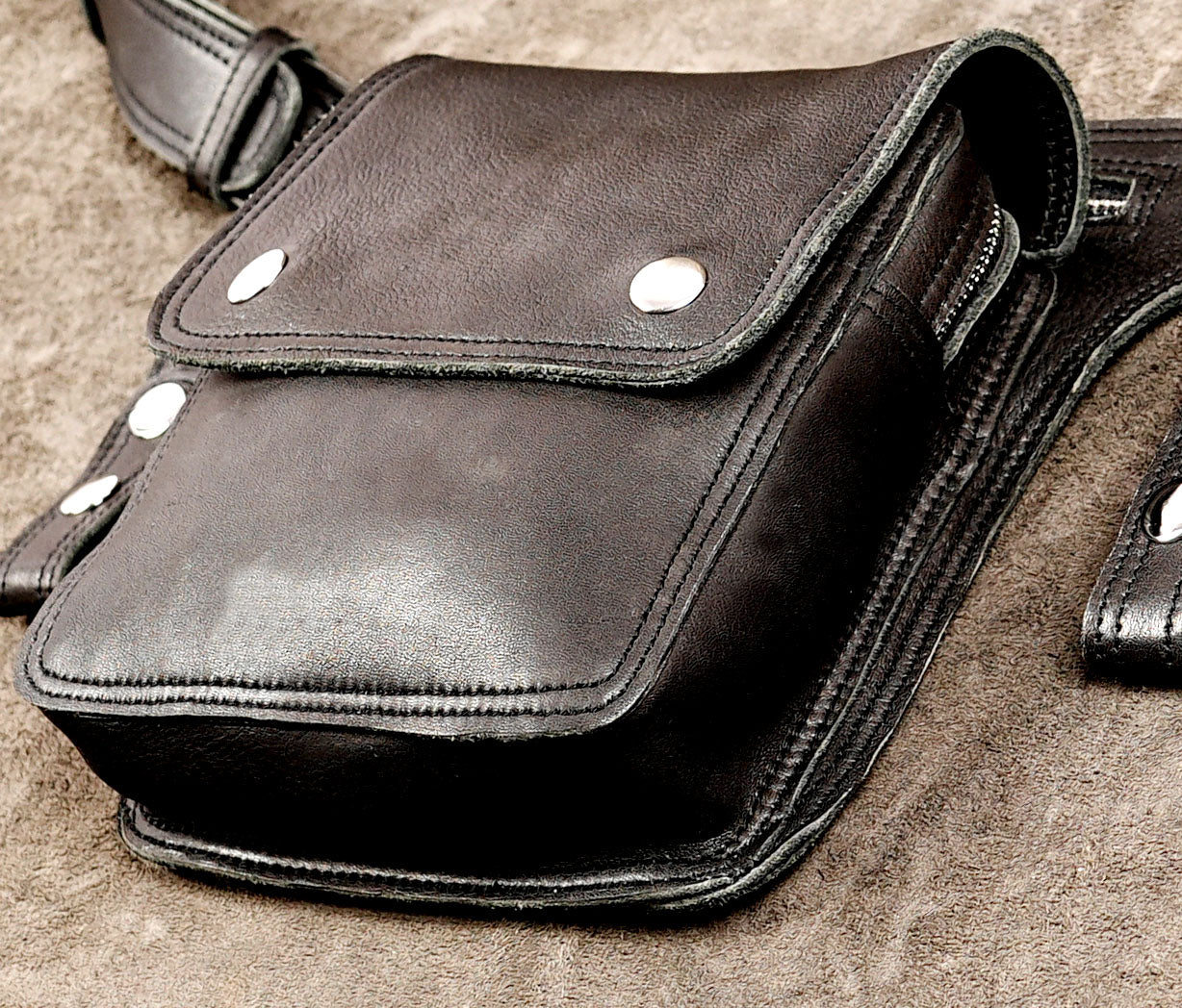 Sleek black leather pouch with snap button closure