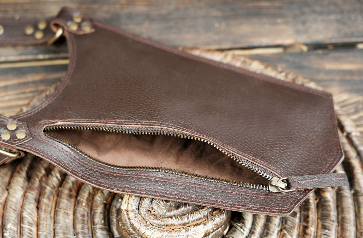 Unisex brown leather utility harness with dual thigh pouches for concerts and festivals.