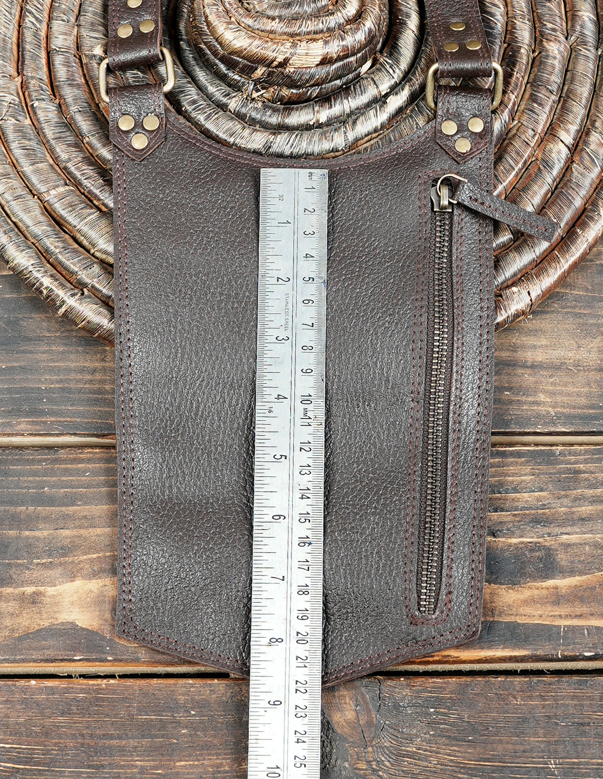 Gothic brown leather double thigh bag harness with decorative metal studs and eyelets.
