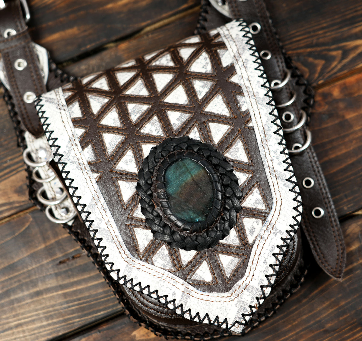 Spiritual leather chest bag with Om symbol and braided ring detail