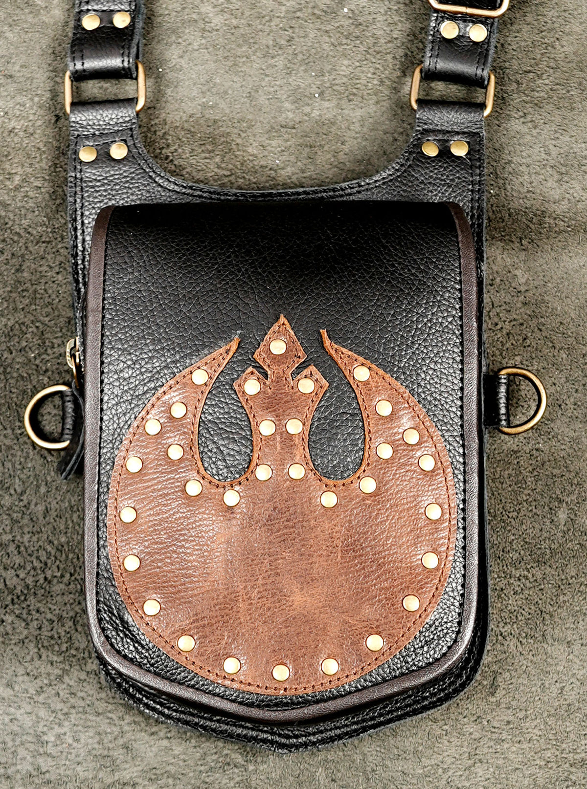 Brown leather body harness featuring custom rebel emblem and pockets