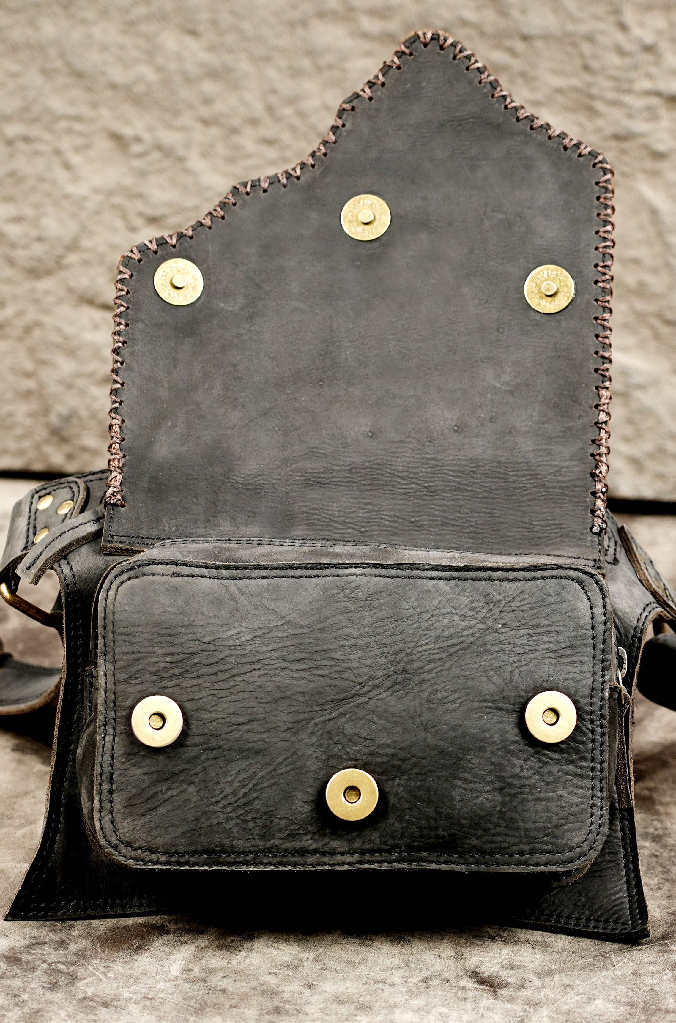 Steampunk-inspired belt bag with brass studs and stone detail
