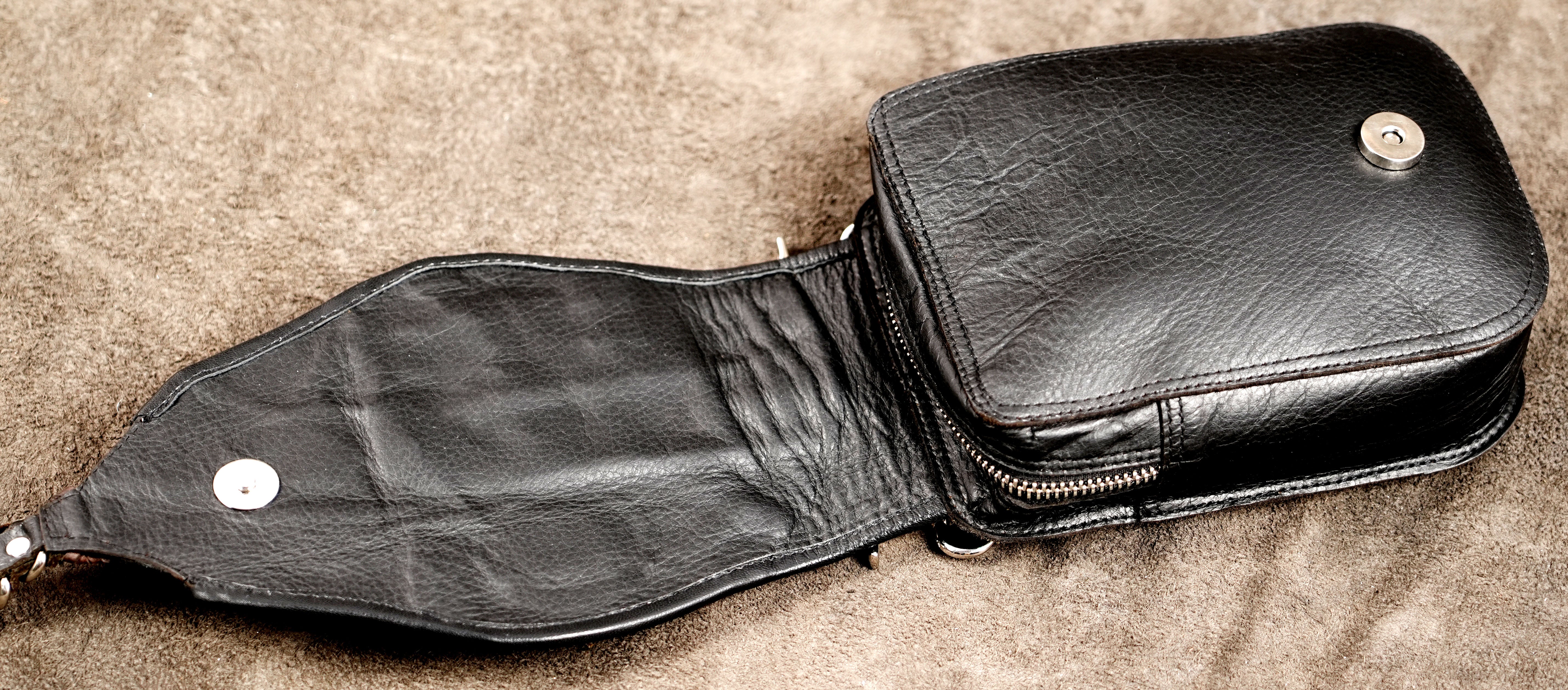 Steampunk-inspired hip pouch with brass studs and leather braiding