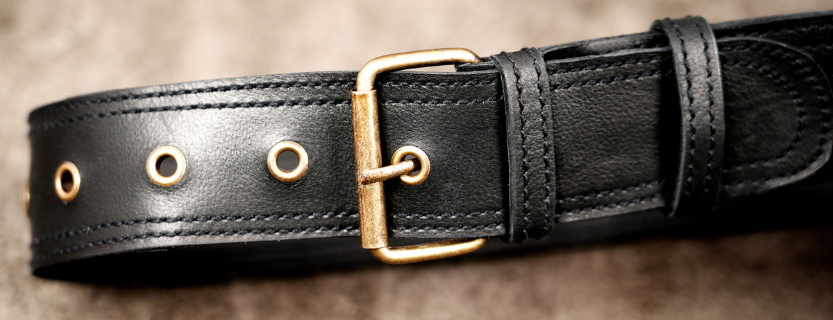 Unisex black leather hip bag with adjustable belt and front pocket