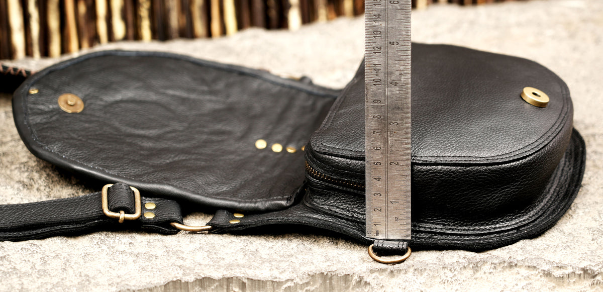 Gothic festival leather harness bag with detailed stitching and metal studs