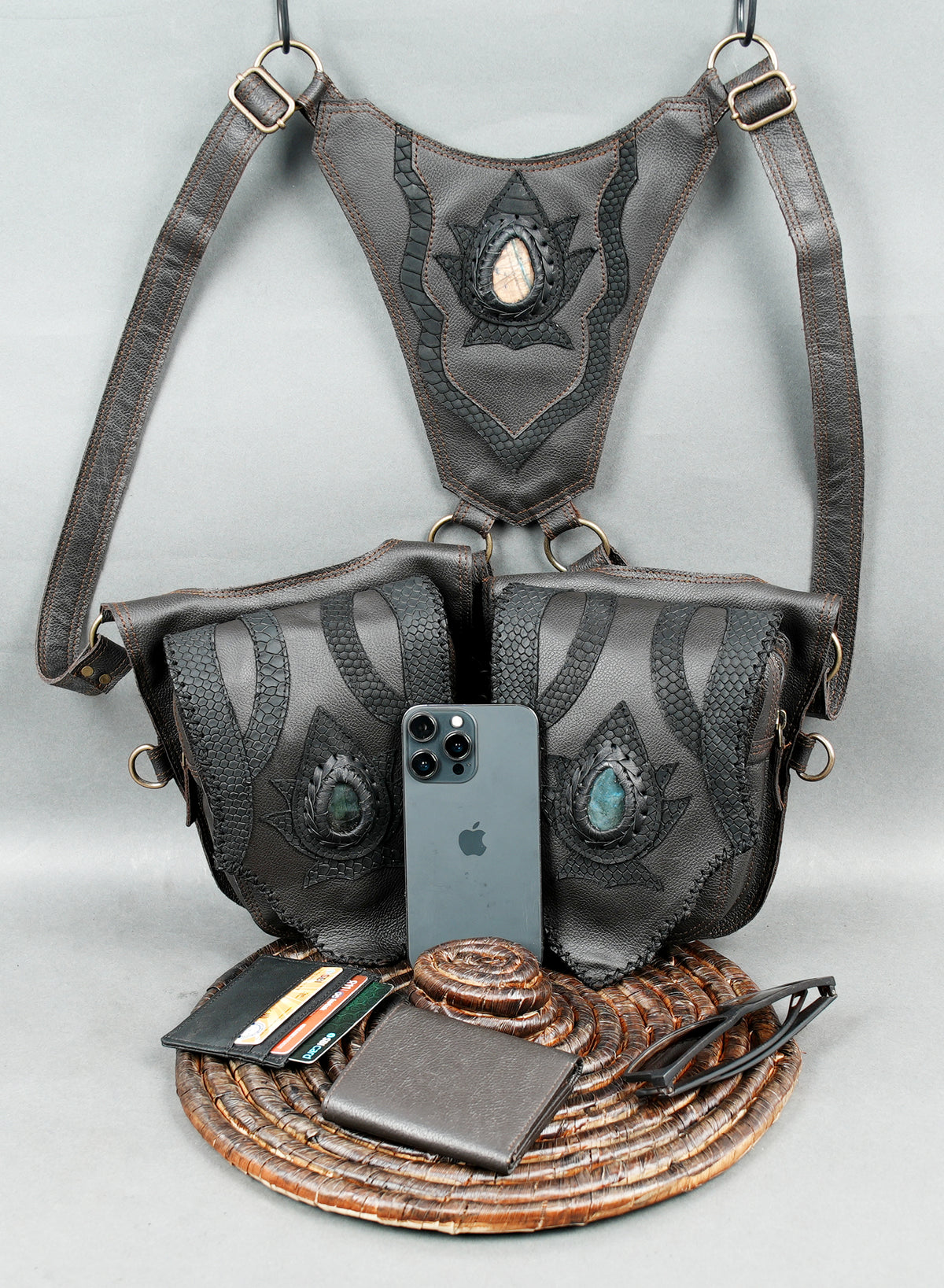 Boho leather festival harness with two front pouches intricate stitching and decorative stones.