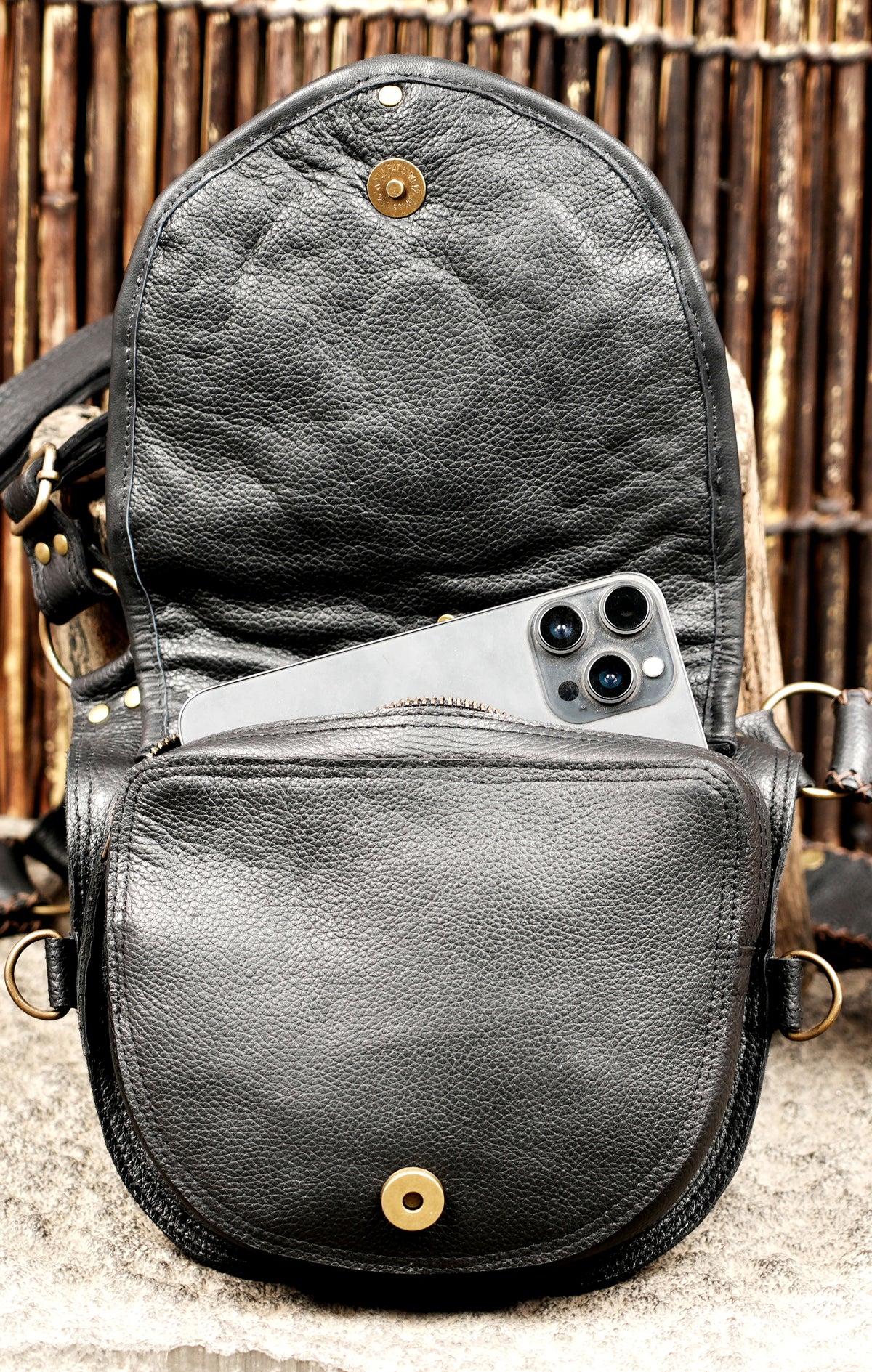 Steampunk leather body bag with decorative panels and antique style metal accents
