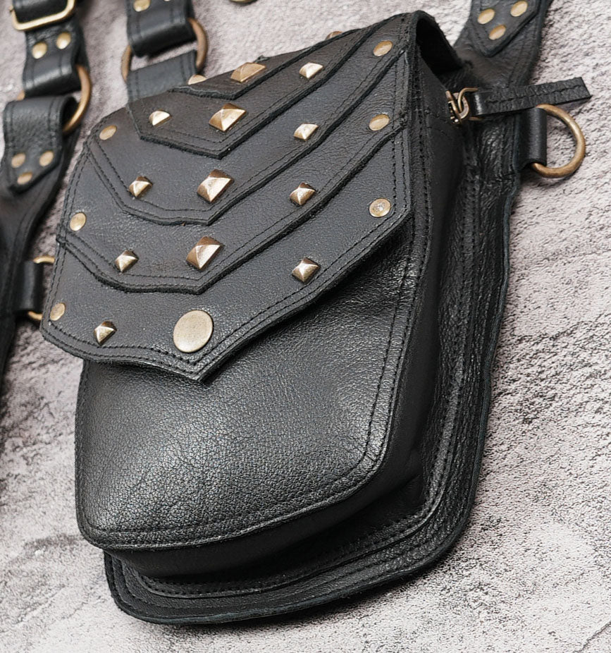 Black leather festival shoulder bag with multiple storage pockets and straps