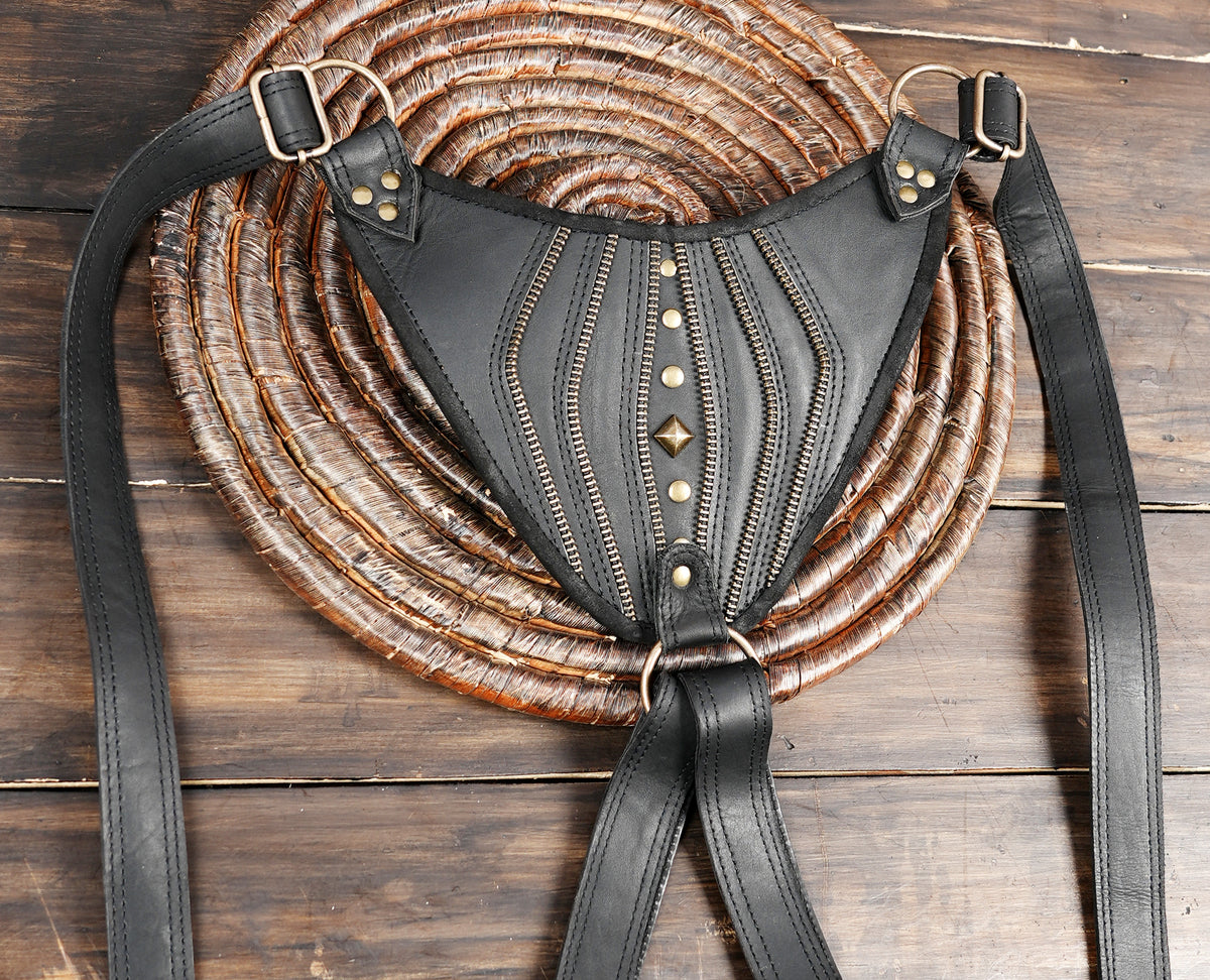 Handcrafted leather double hip pouch with adjustable buckled straps and studded flaps
 