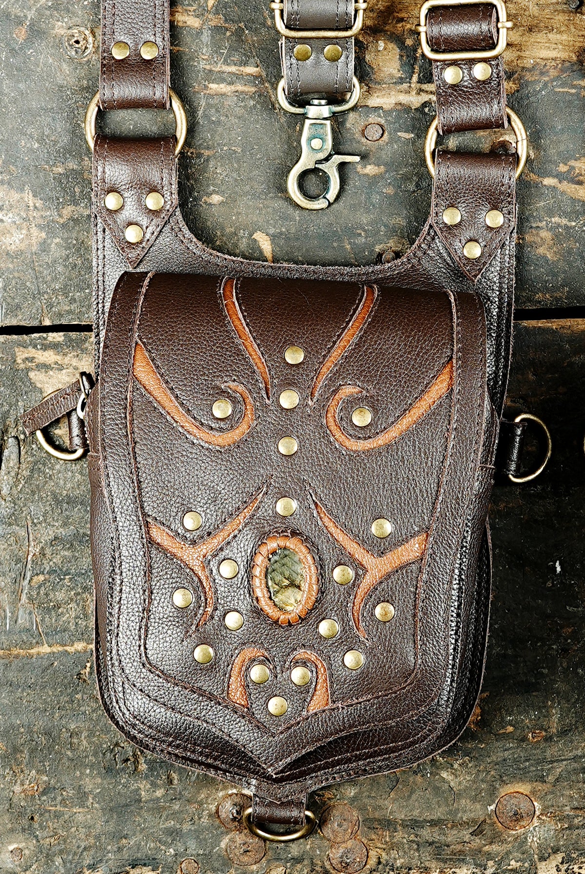Unisex black leather shoulder harness bag with two decorative utility pouches