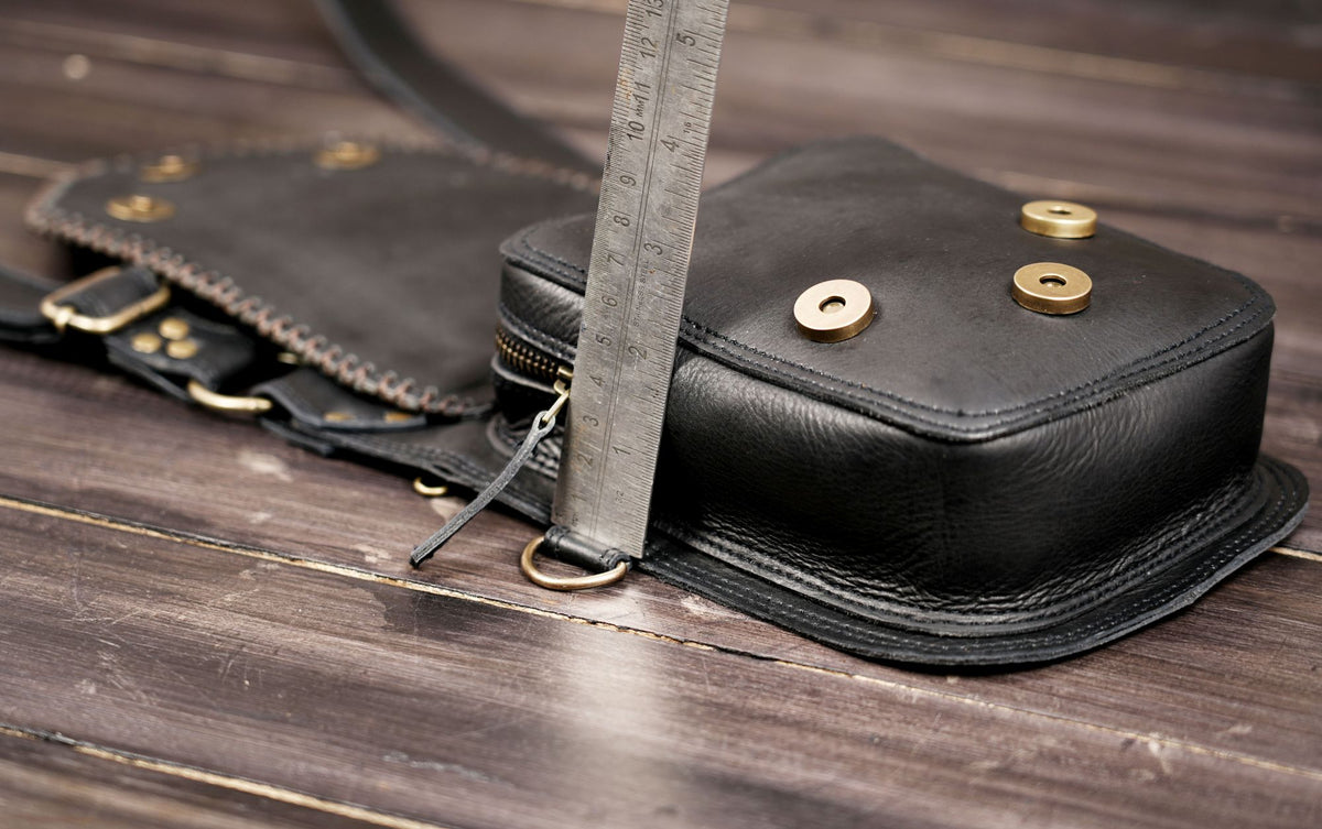 Artisan leather double hip bags with layered flaps and metal embellishments
 