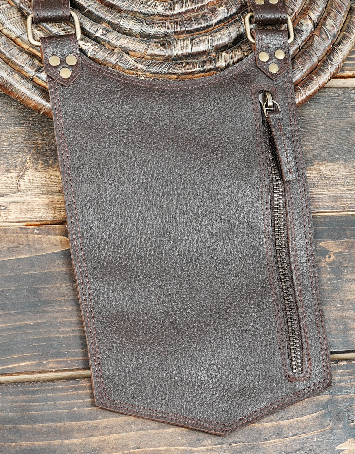 Brown leather double leg pouch harness with antique brass hardware and adjustable fittings.