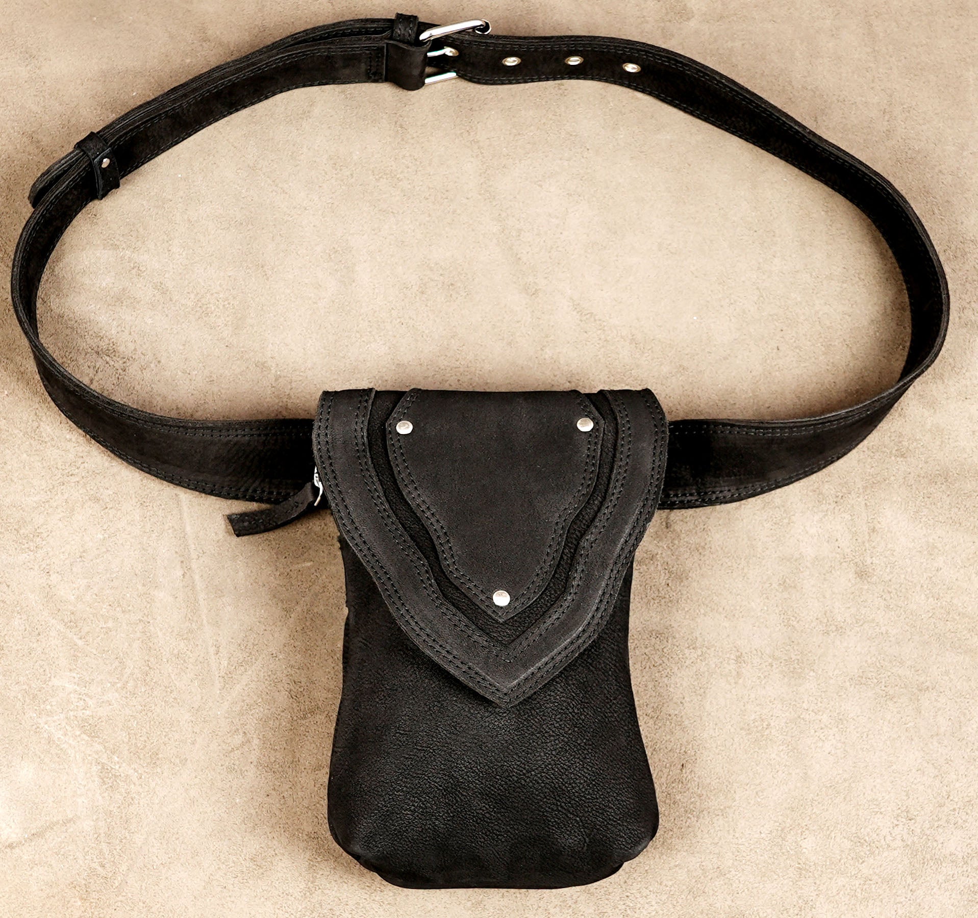 Suede finish leather pouch with arrow shaped flap closure