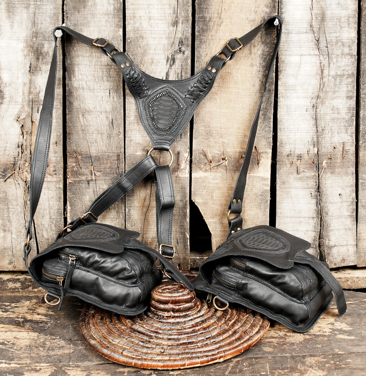 Unisex black leather utility bag with double holster pockets and adjustable shoulder straps