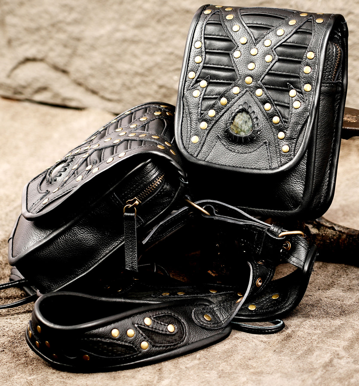 Gothic black leather harness bag with gold tone studs and adjustable straps
 