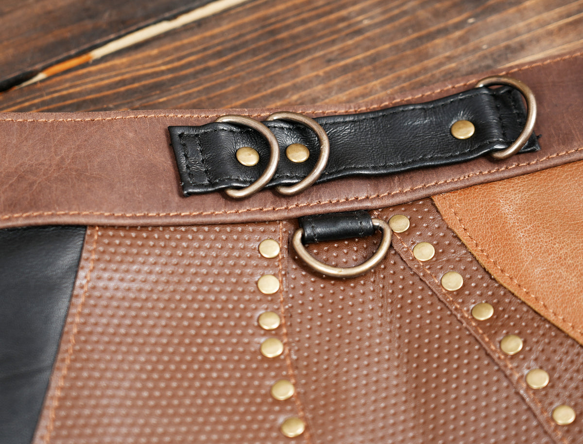 Tribal leather mini skirt with studded leaf applique, flat lay