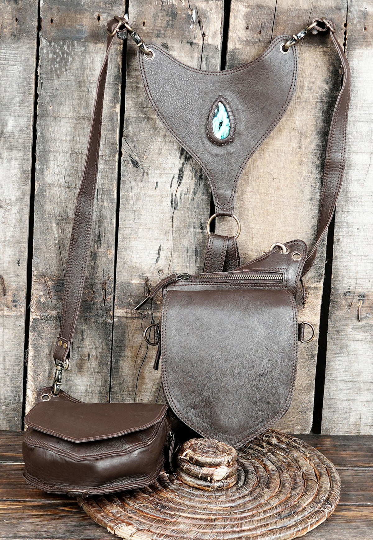 Brown leather rave outfit accessory with double hip pouches and metal hardware

