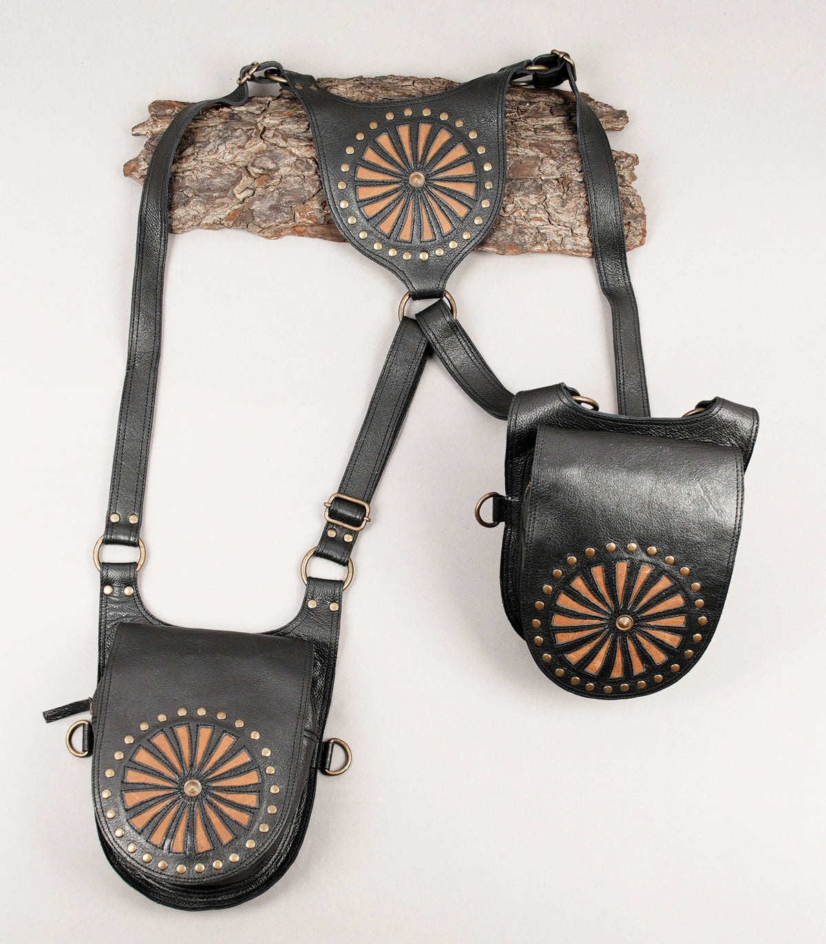 Black leather shoulder holster bag with decorative sunburst design
