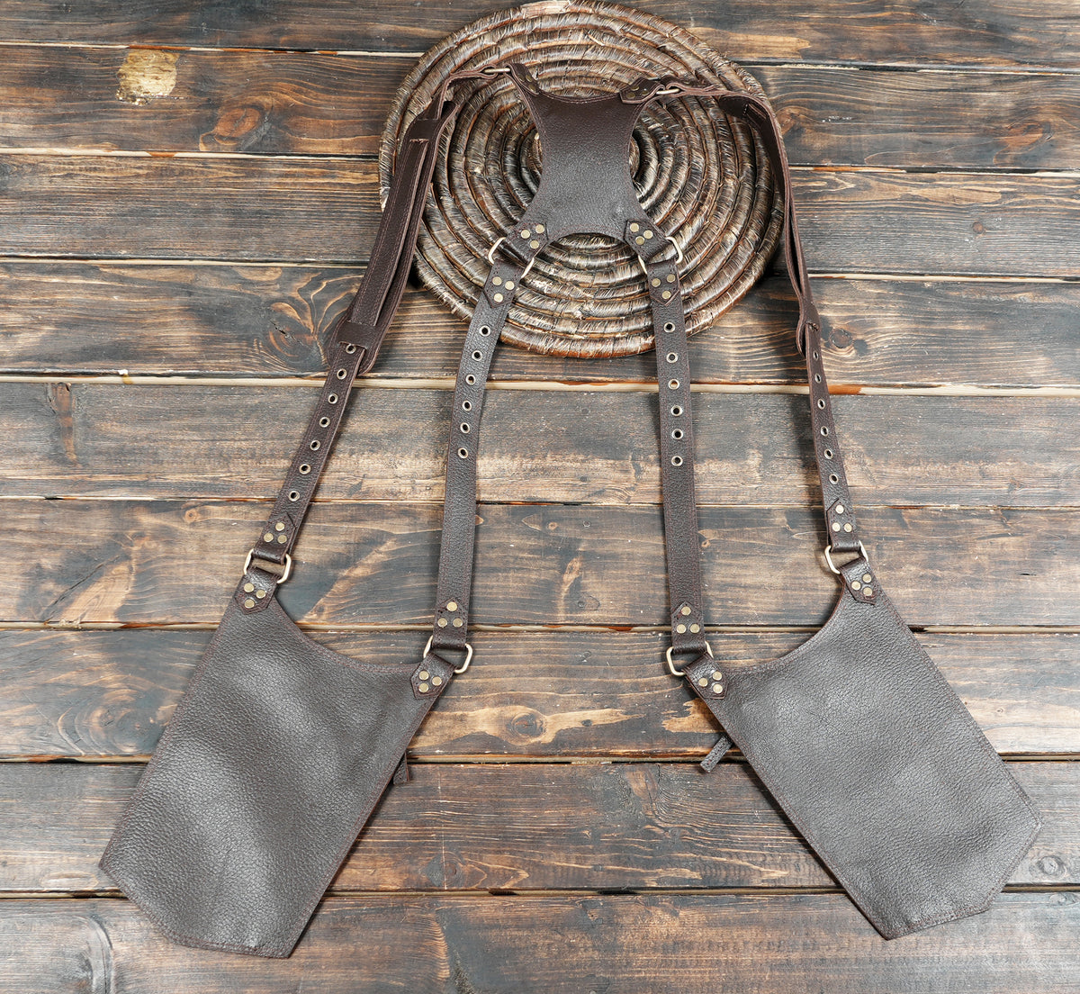 Adjustable brown leather thigh holster bags with studded straps and functional storage.