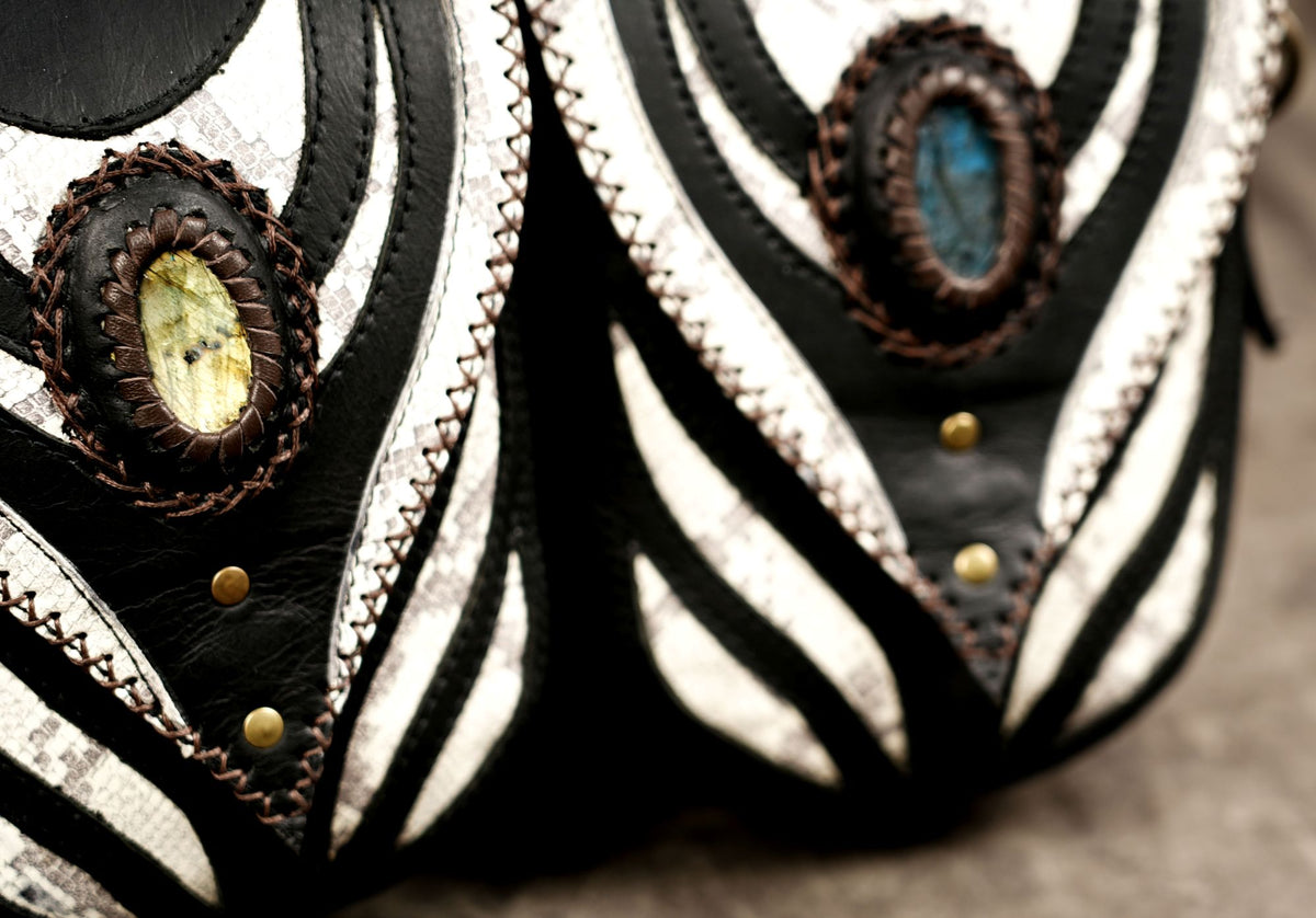 Edgy black utility holster with matching pouches and metal d-rings.