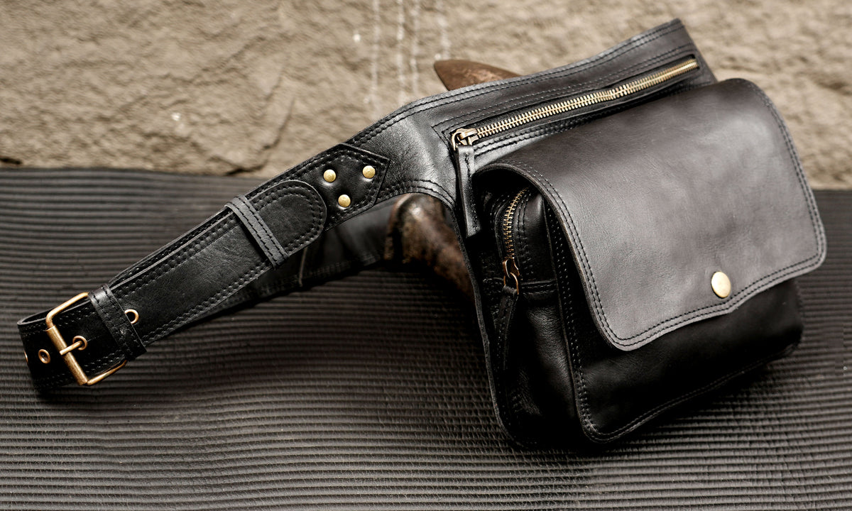 Unisex black leather waist bag with adjustable buckle strap
