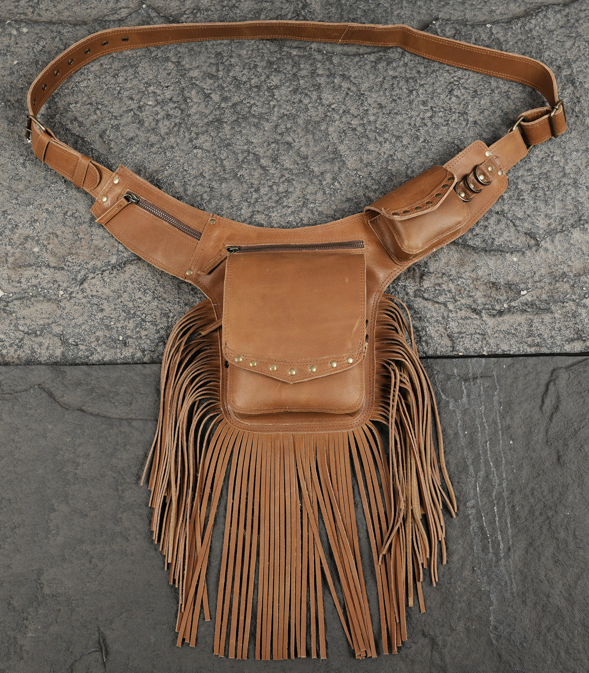 Unisex fringe leather hip bag on neutral backdrop