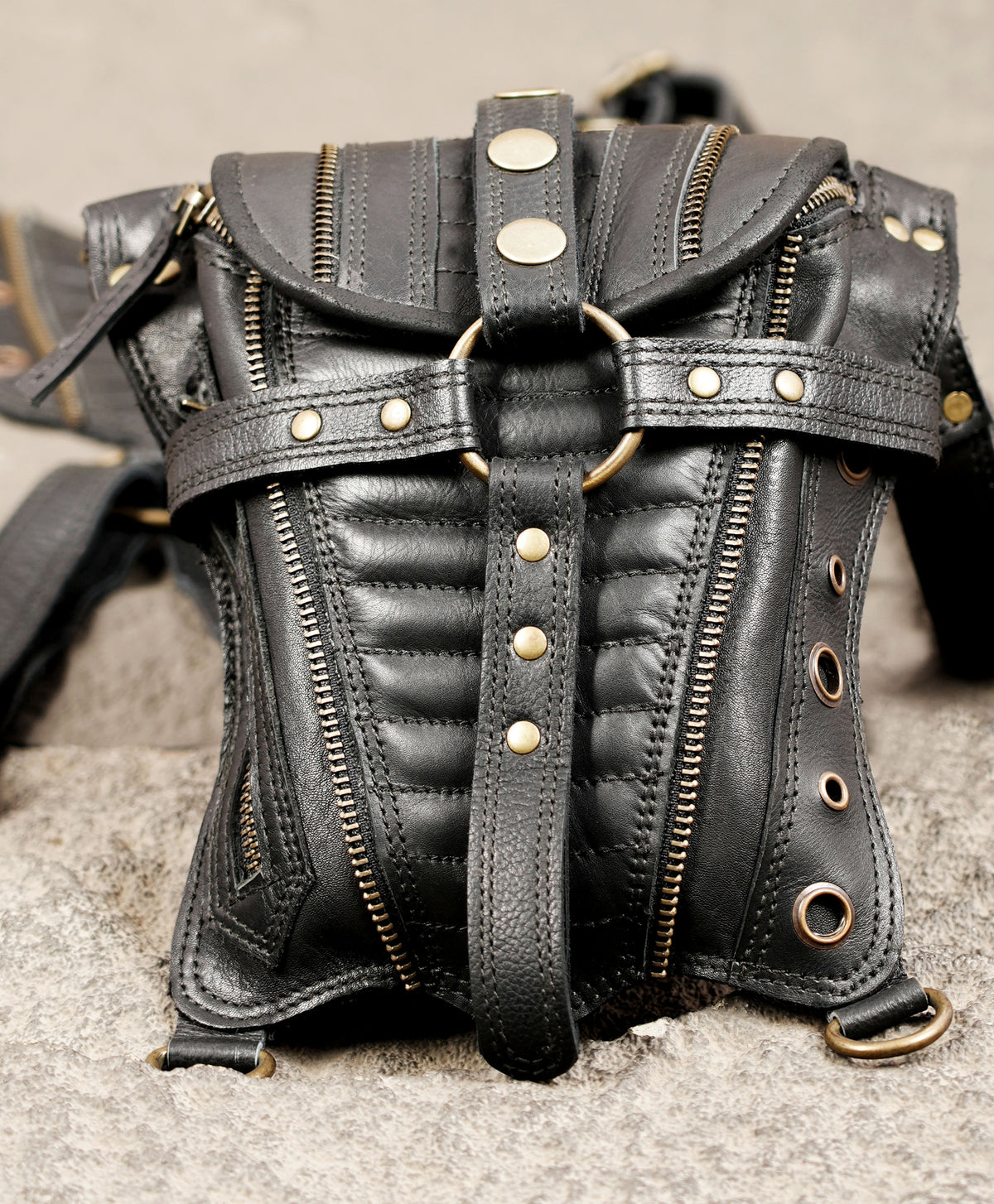 Handcrafted black steampunk utility bag with multiple zippers and antique brass fittings