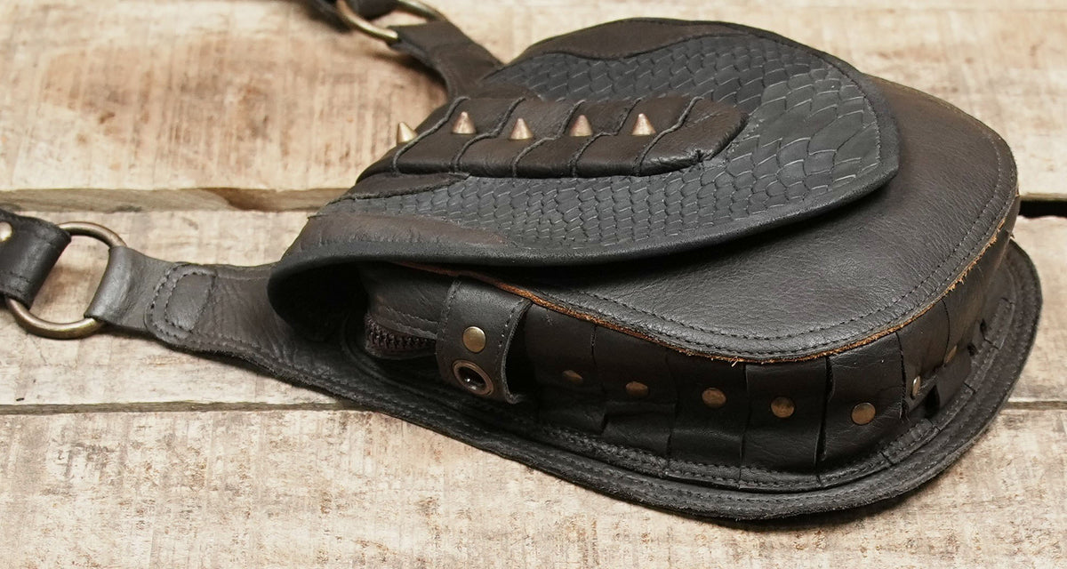 Steampunk-inspired leather harness with decorative stitching and brass-tone buckles