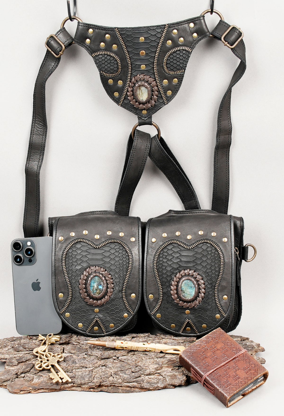 Black leather costume harness with matching pouches metal rings and decorative studs