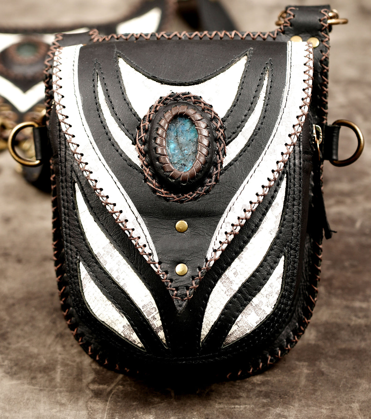 Black and white festival harness with dual utility pouches and gemstone accents.