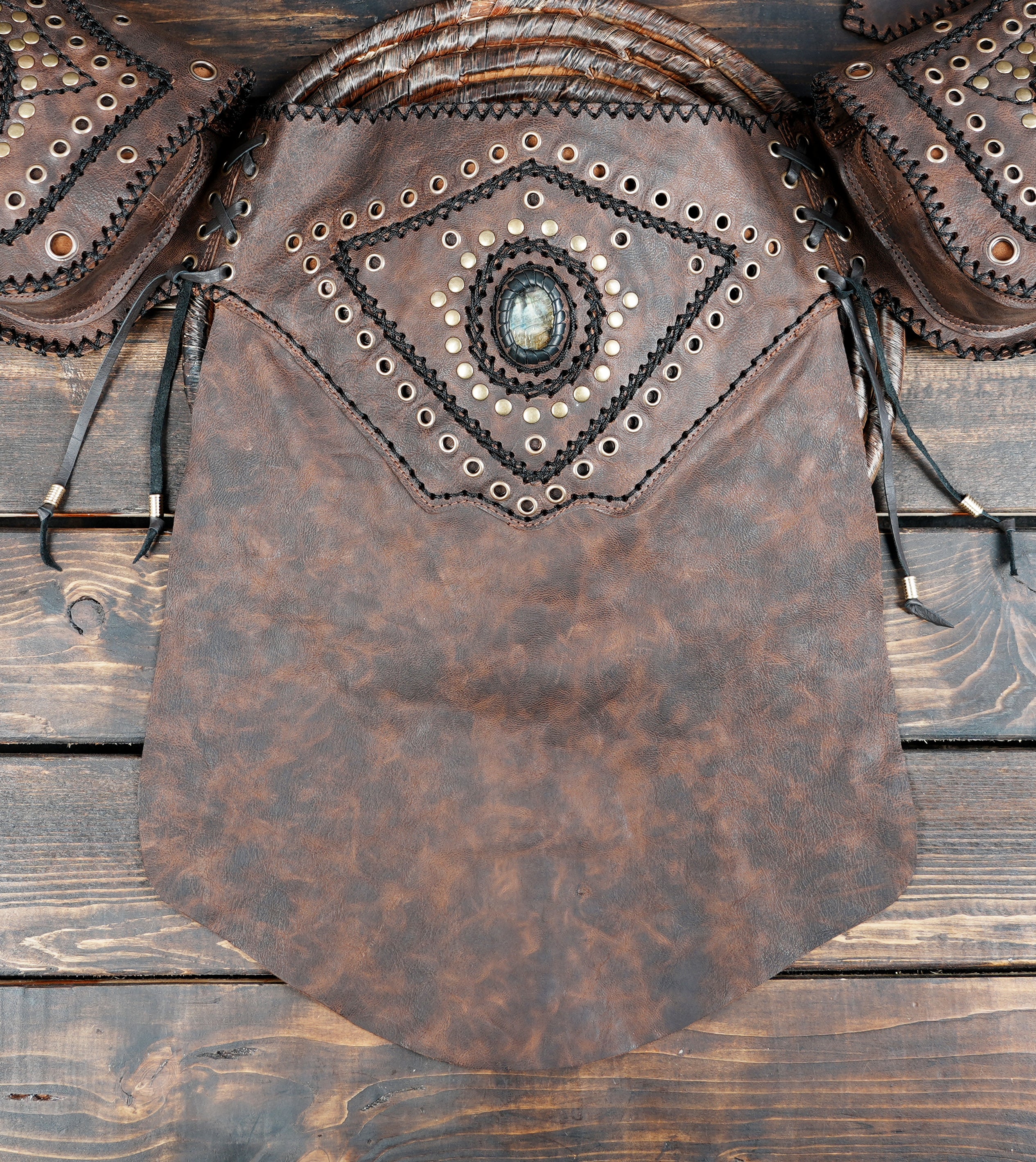 Warrior leather skirt with studded diamond design, flat lay