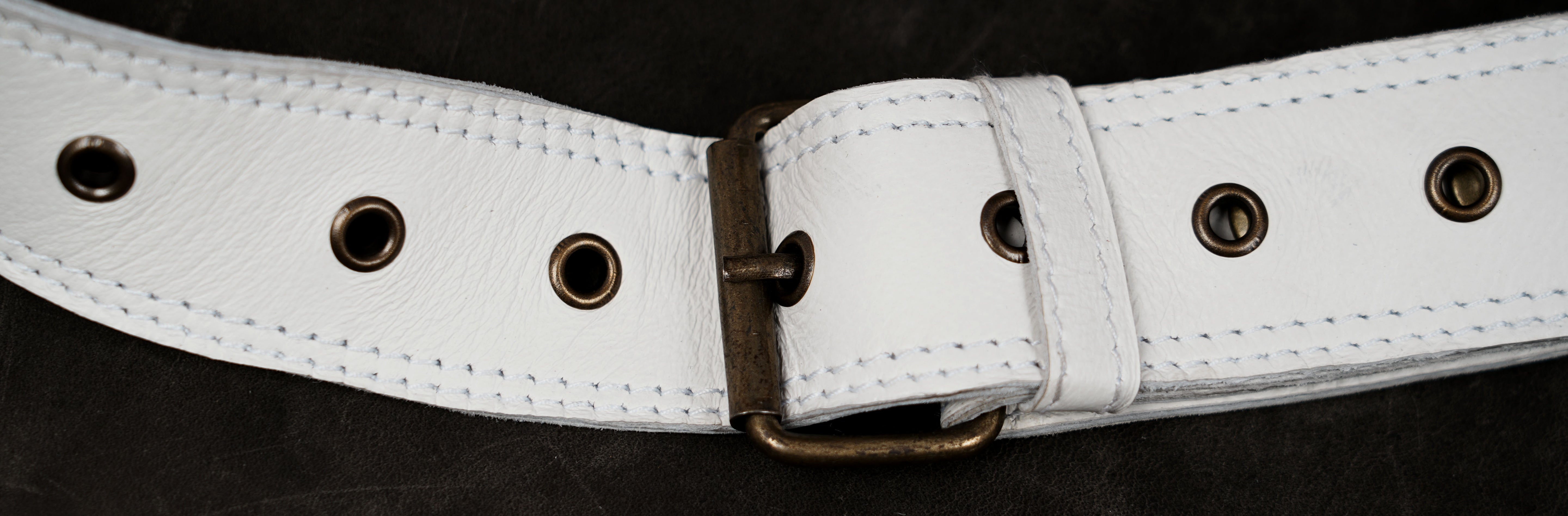 White leather pocket belt featuring decorative brass studs