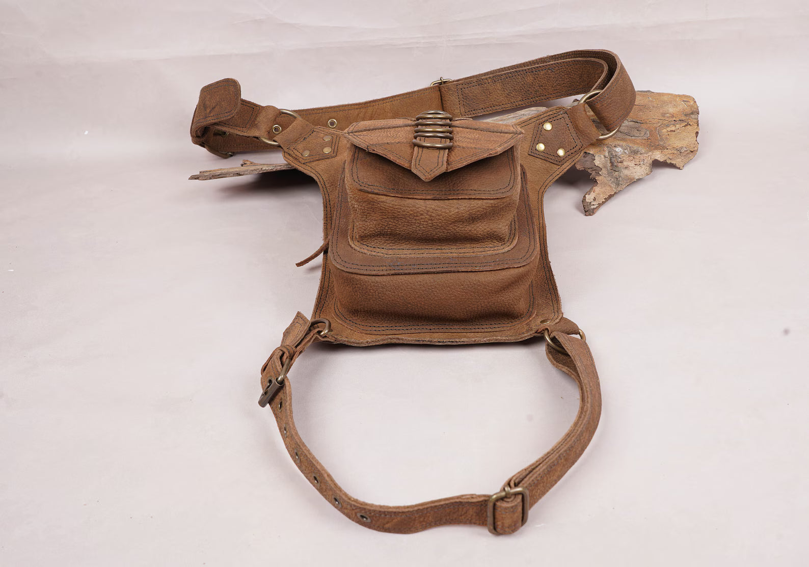 Stylish leather thigh bag with zipper compartment and flap pocket