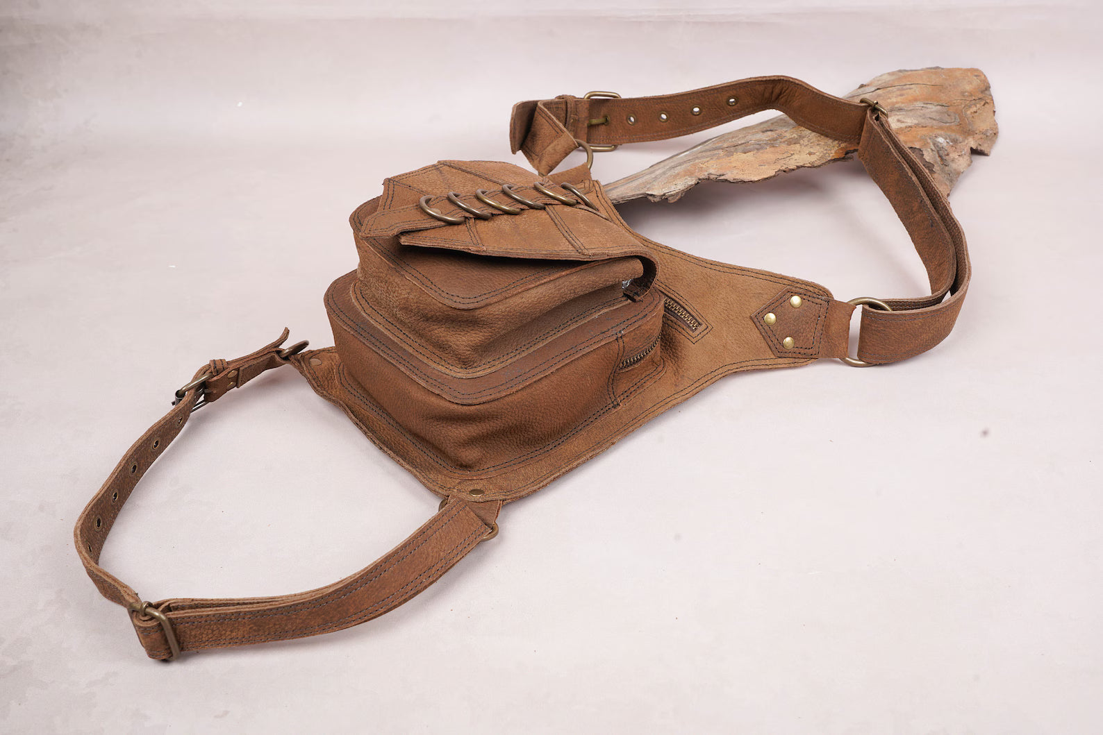 Brown leather thigh holster belt with secure front flap design