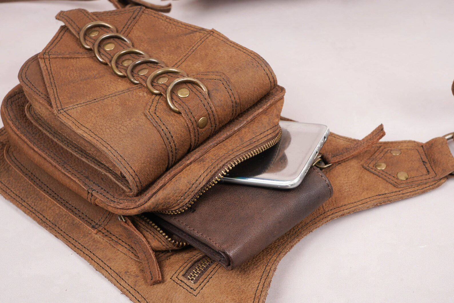 Rustic leather waist holster with adjustable strap and zipper closure