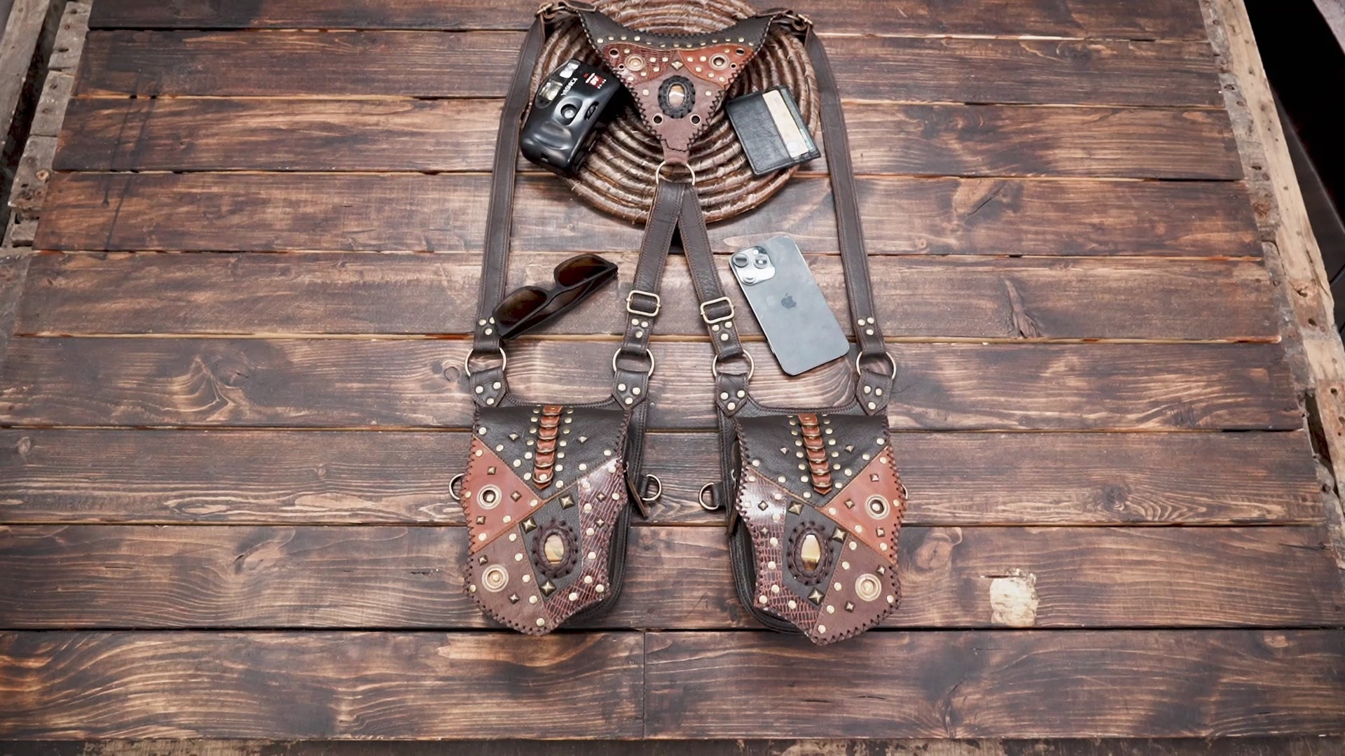 leather holster harness with adjustable straps and pockets